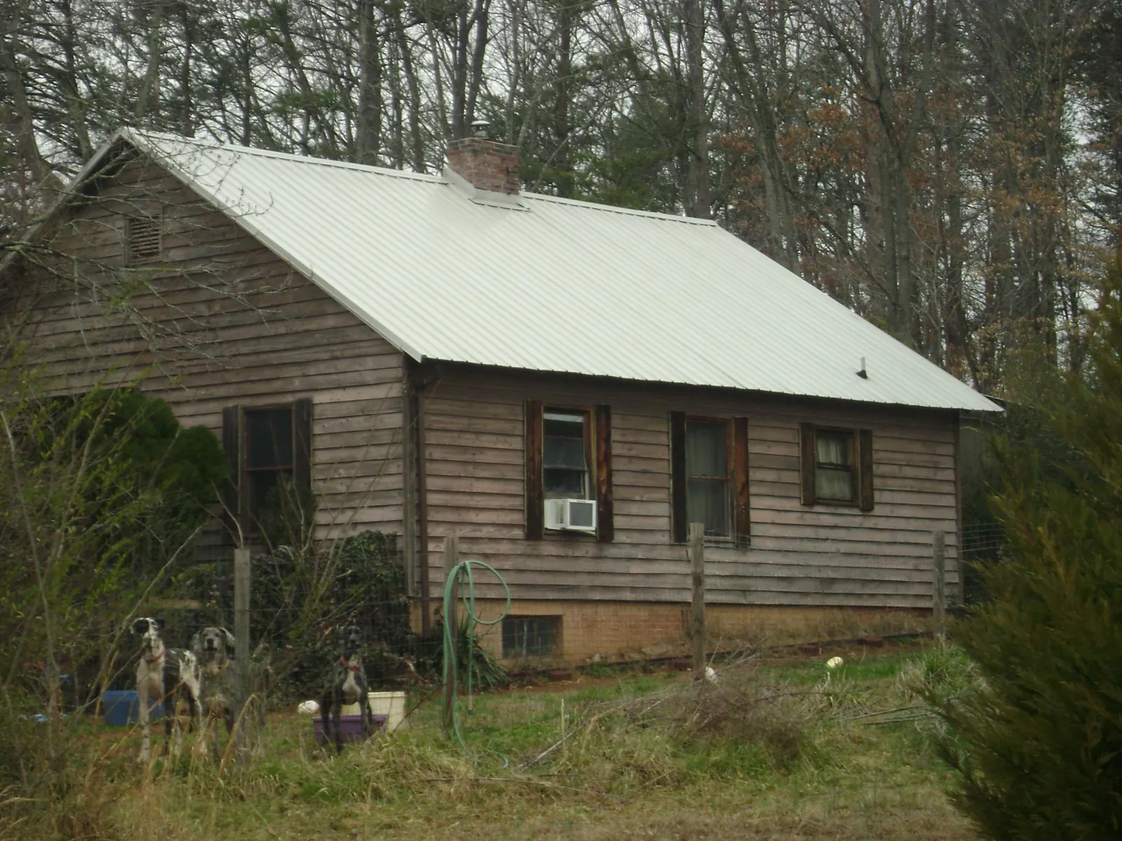 White metal roof on an old wood sided farmhouse, from a Metal Roof Installation job in Norristown